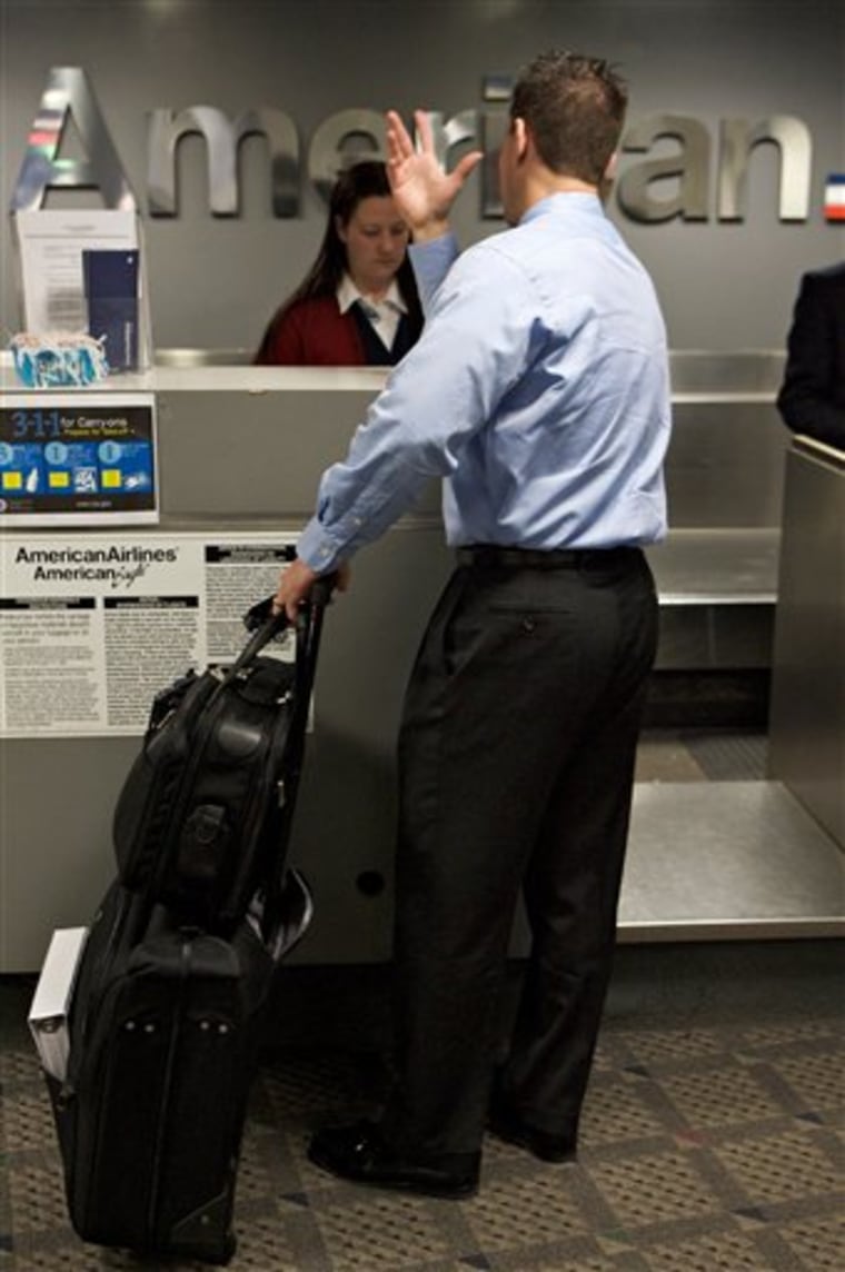 Business traveler Brian Shenberg, a salesman from Chicago, checks in Feb. 19, 2008, at the Bob Hope Airport in Burbank, Calif. U.S. companies are forecast to spend 5 percent more on travel in 2011 than they did the year before.